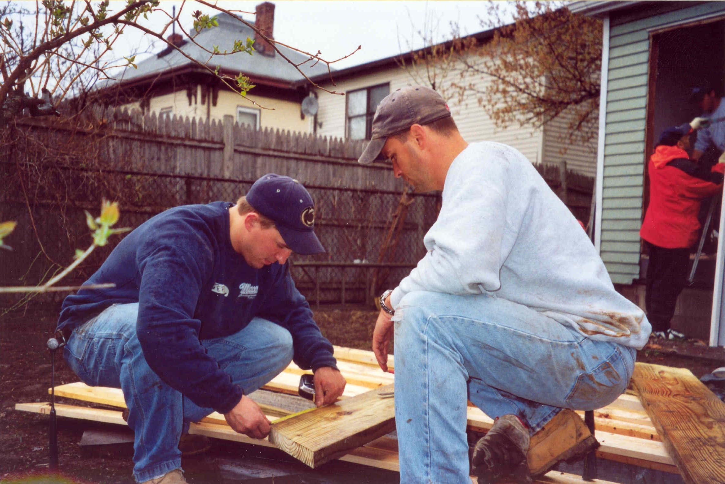 Chuck Tobin and Jeff Palmer work on a community service project together (2003)
